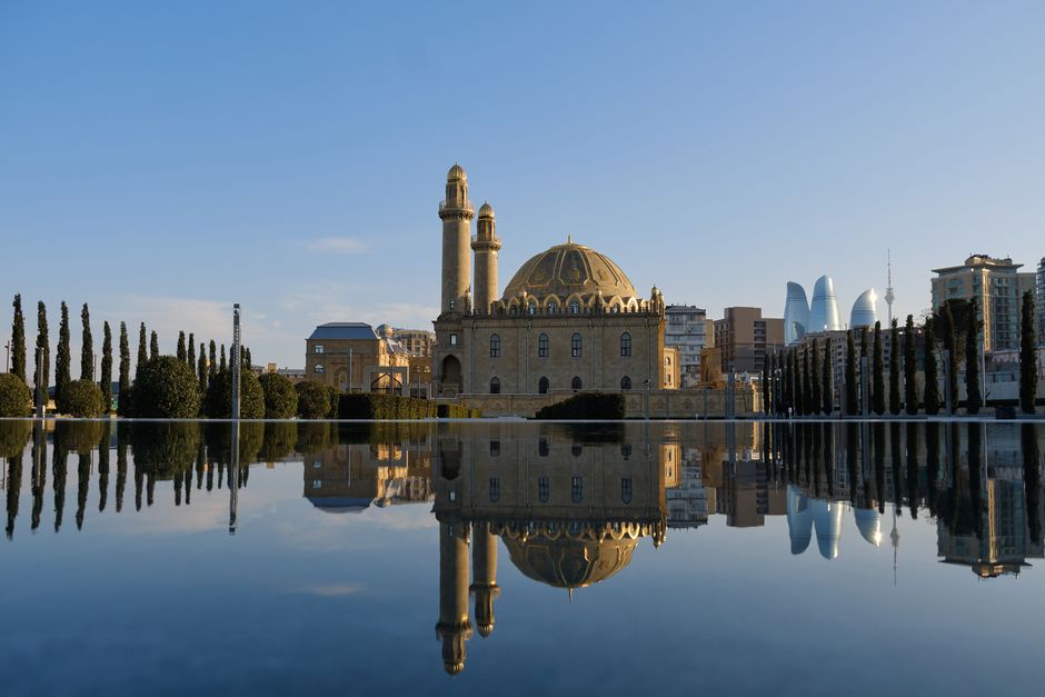Breathtaking reflection of Taza Pir Mosque in Baku, Azerbaijan, showcasing Islamic architecture.