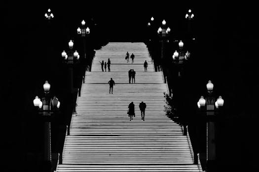Dramatic night scene showcasing silhouettes on illuminated stairs in Baku, Azerbaijan.