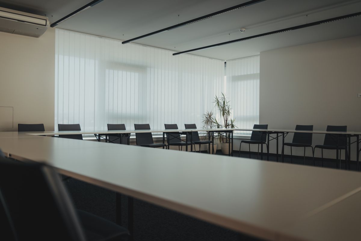 Modern communal room with hard surfaces and large windows