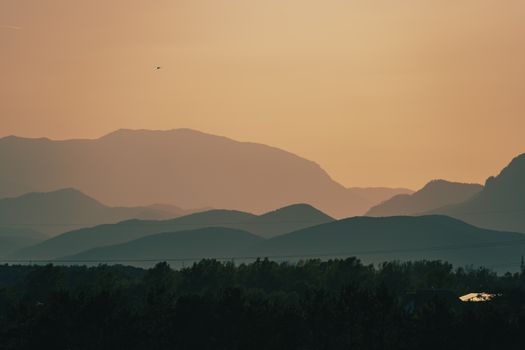 Beautiful rolling hills under a warm sunset sky in Steiermark, Austria, showcasing nature's tranquility.