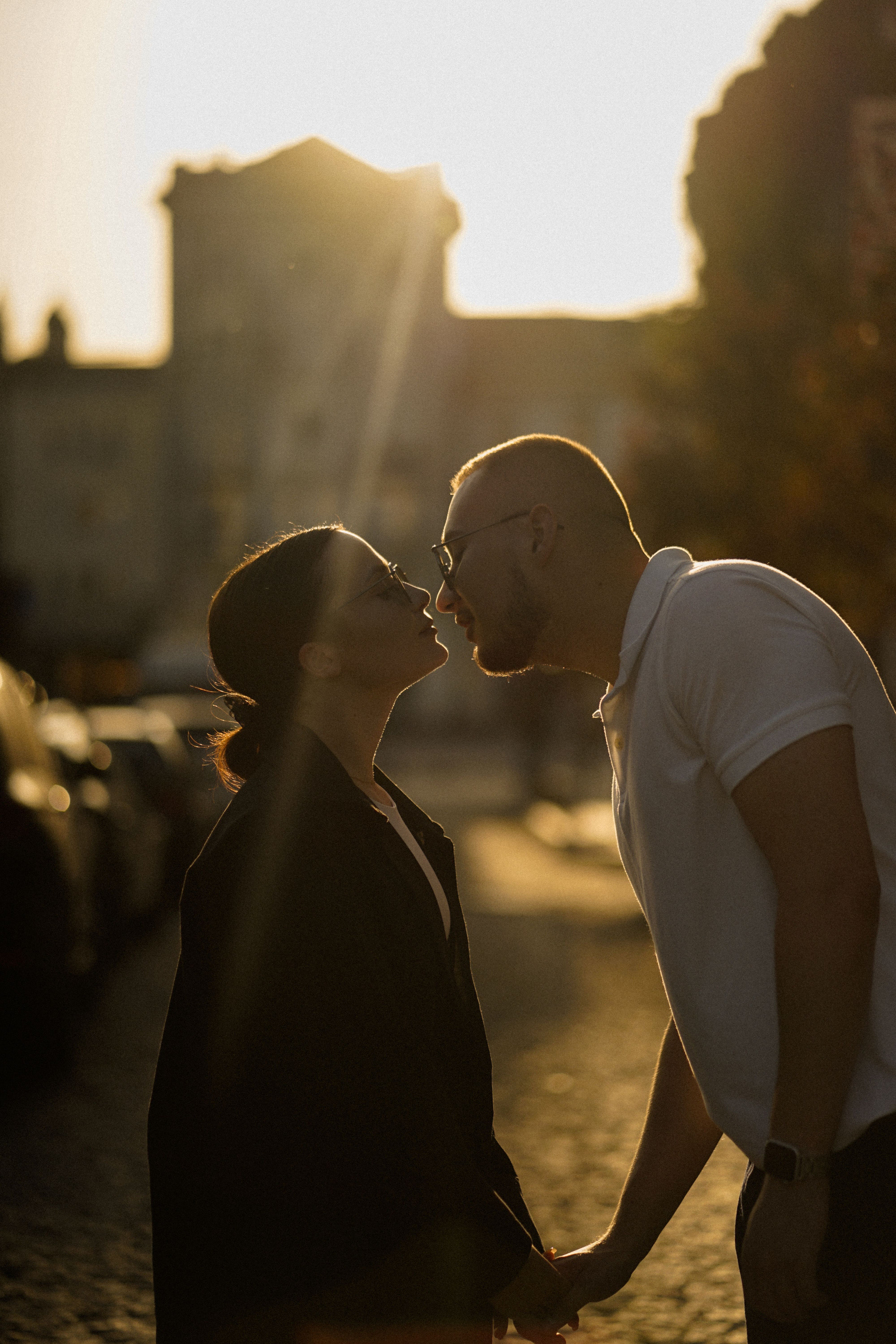Silhouette of a couple kissing in Ternopil, Ukraine during sunset. Romantic atmosphere.