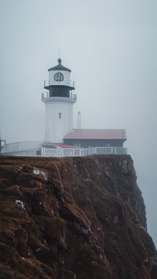 Fog over Lighthouse on Cliff