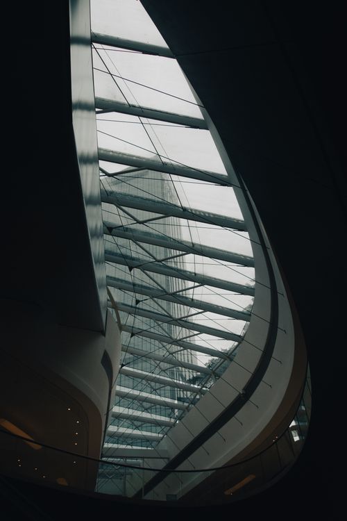 Free Low angle view of a modern building's glass ceiling showcasing architectural elegance. Stock Photo