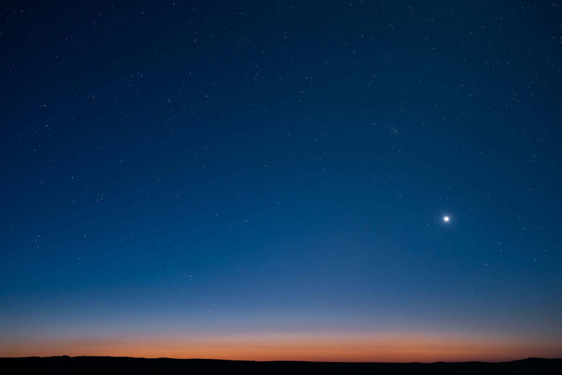 Starry night sky at dusk with visible horizon in East Wenatchee, Washington.