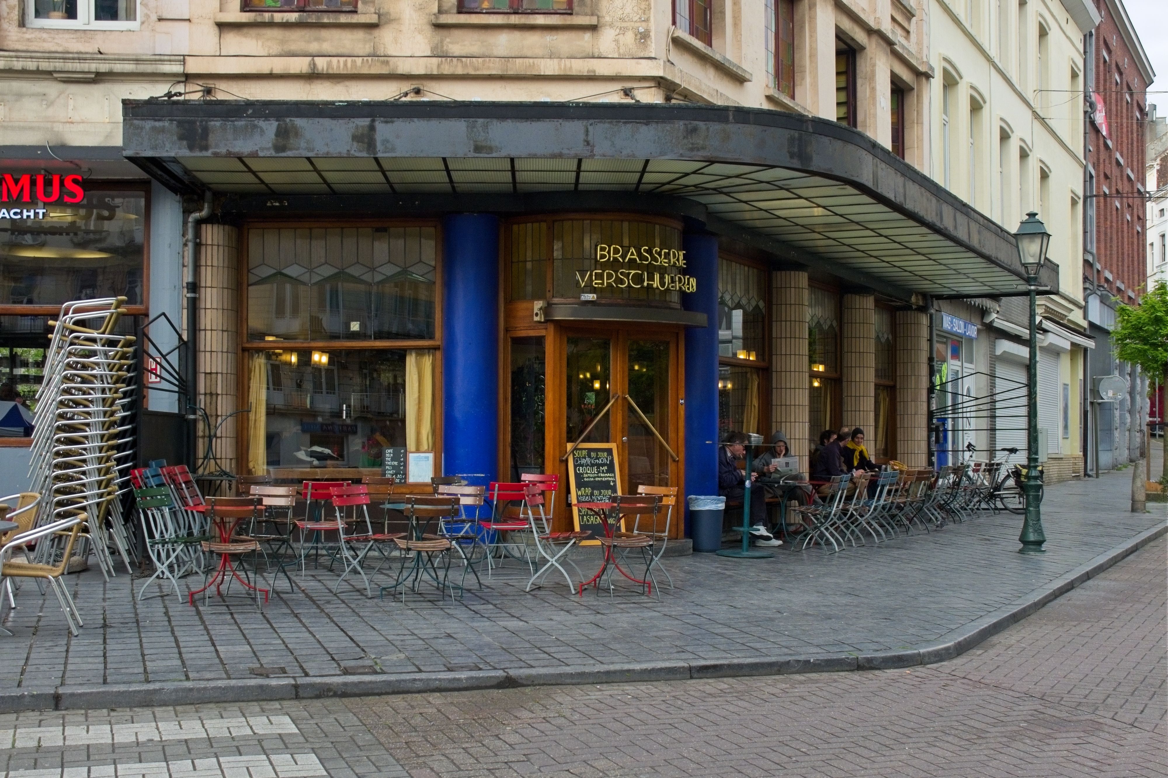 A cozy European café with outdoor seating on a quiet city street, perfect for urban dining.