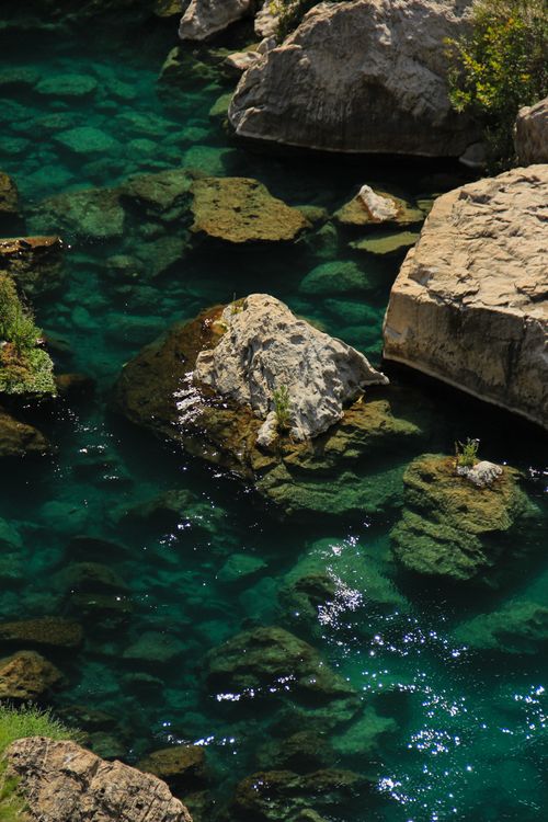 Free A pristine stream flows over rocks creating a serene natural scene, perfect for nature lovers. Stock Photo