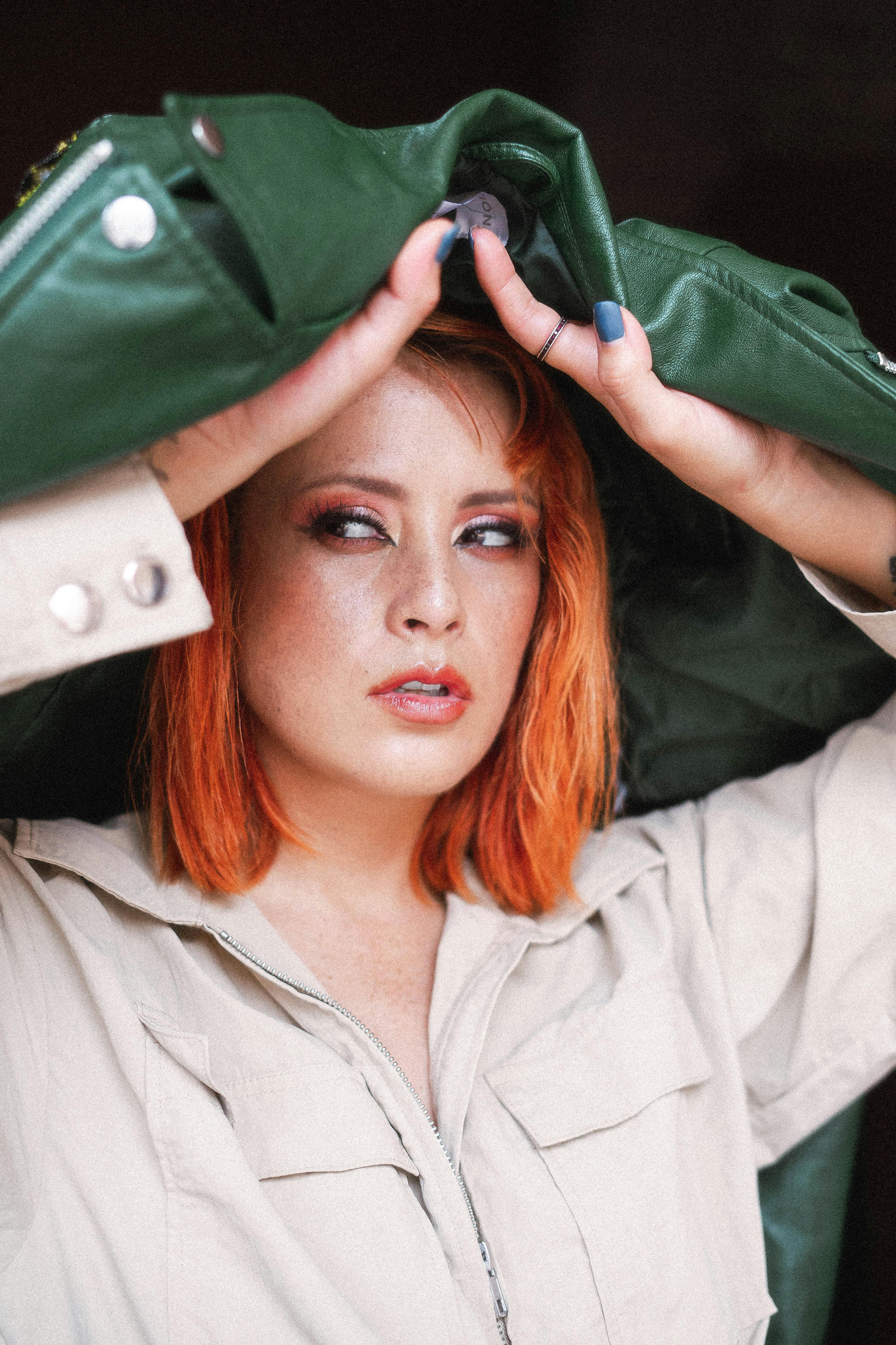 Portrait of a woman with red hair holding a jacket in Morelia, Mexico.