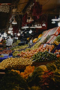 Colorful indoor market scene with various fruits and vegetables on display.