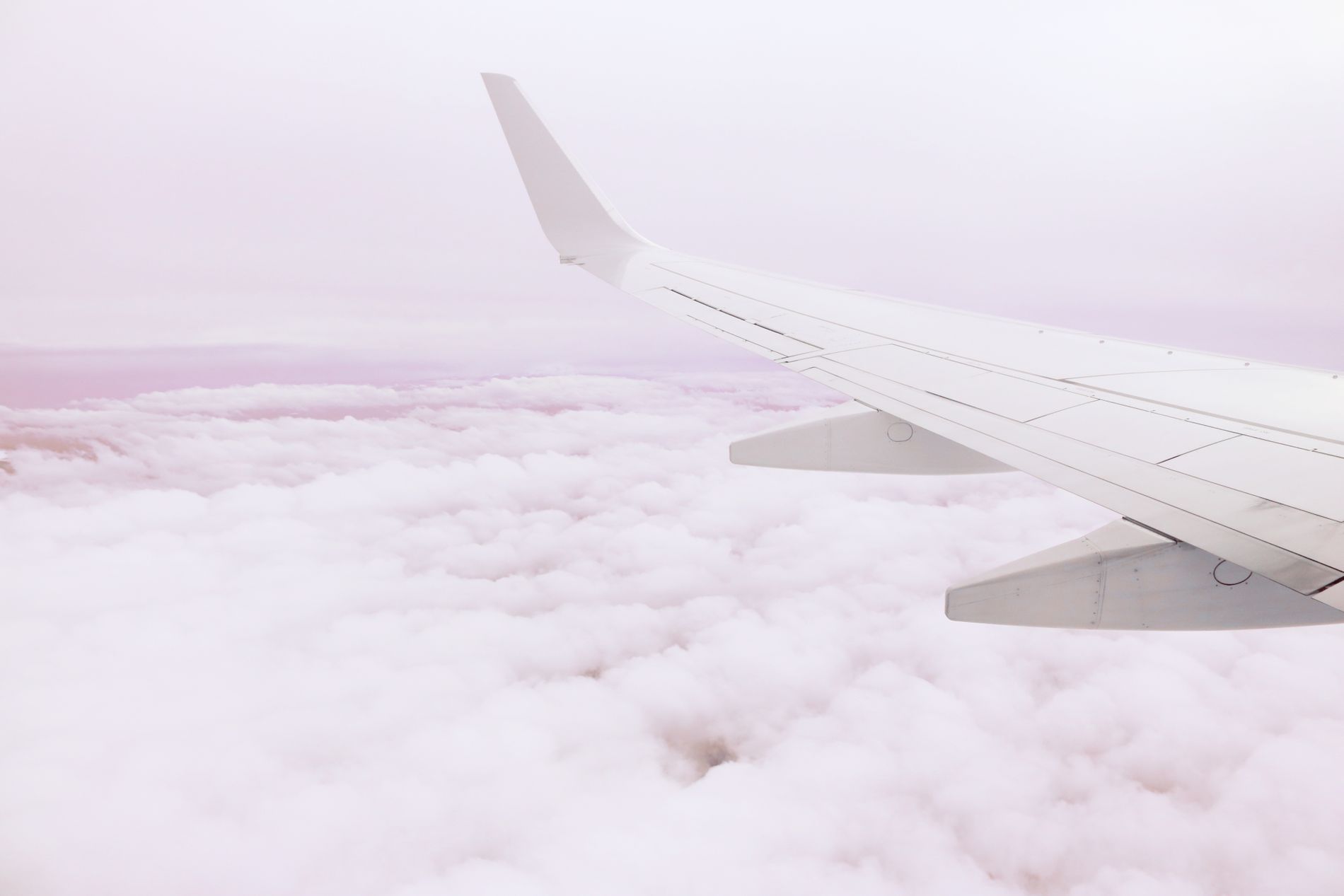 An aircraft wing above the clouds