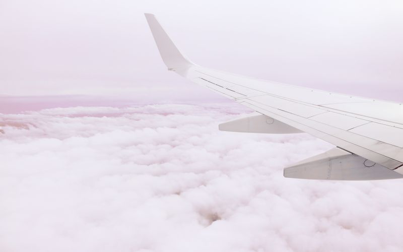 View of an airplane wing above the clouds