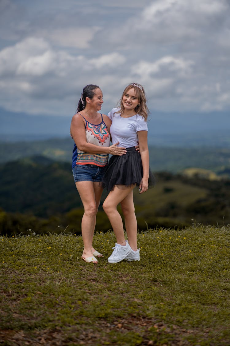 Smiling Mother And Daughter On Hilltop