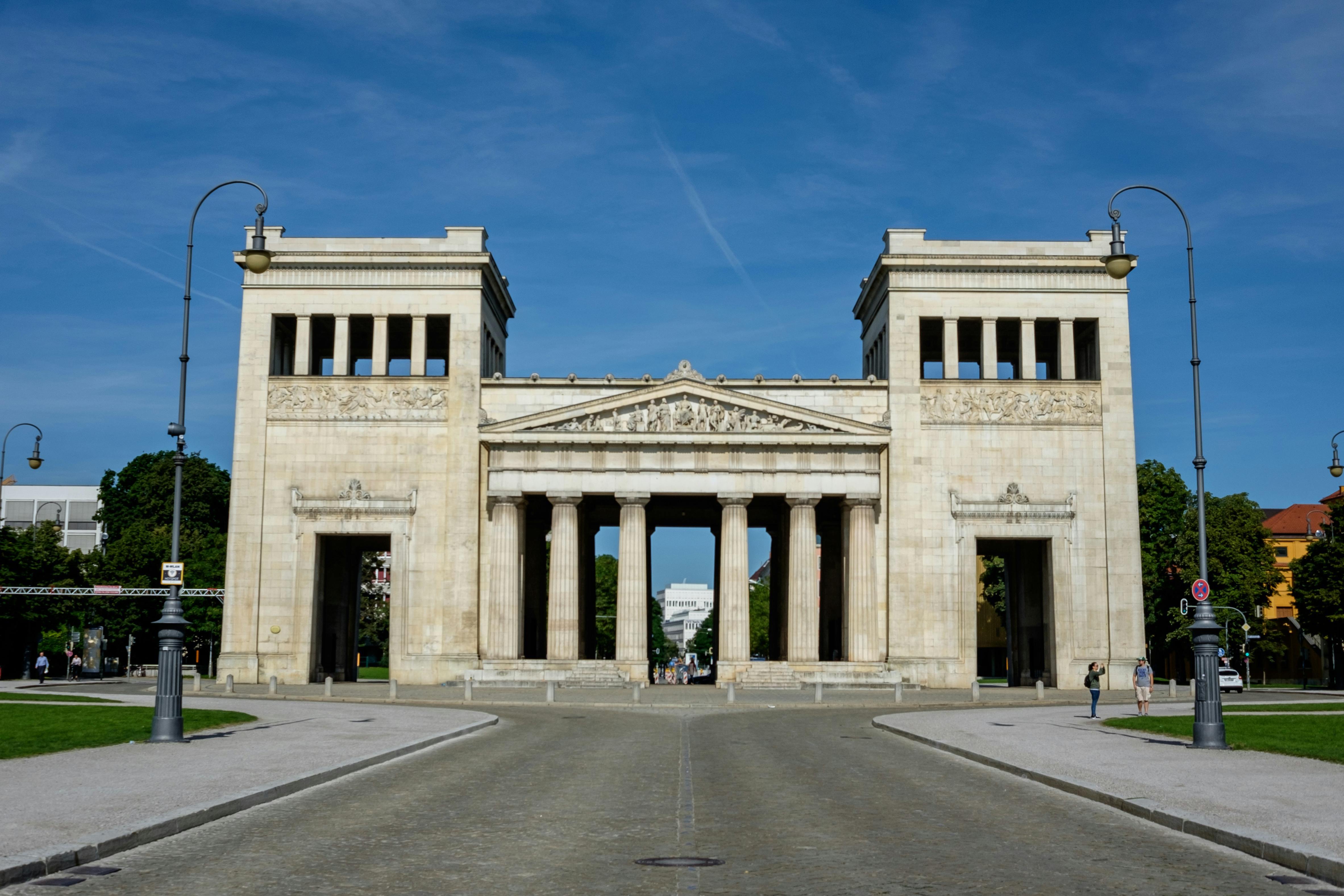 Historic Propylaea Gate in Munich's Königsplatz under a clear sky.