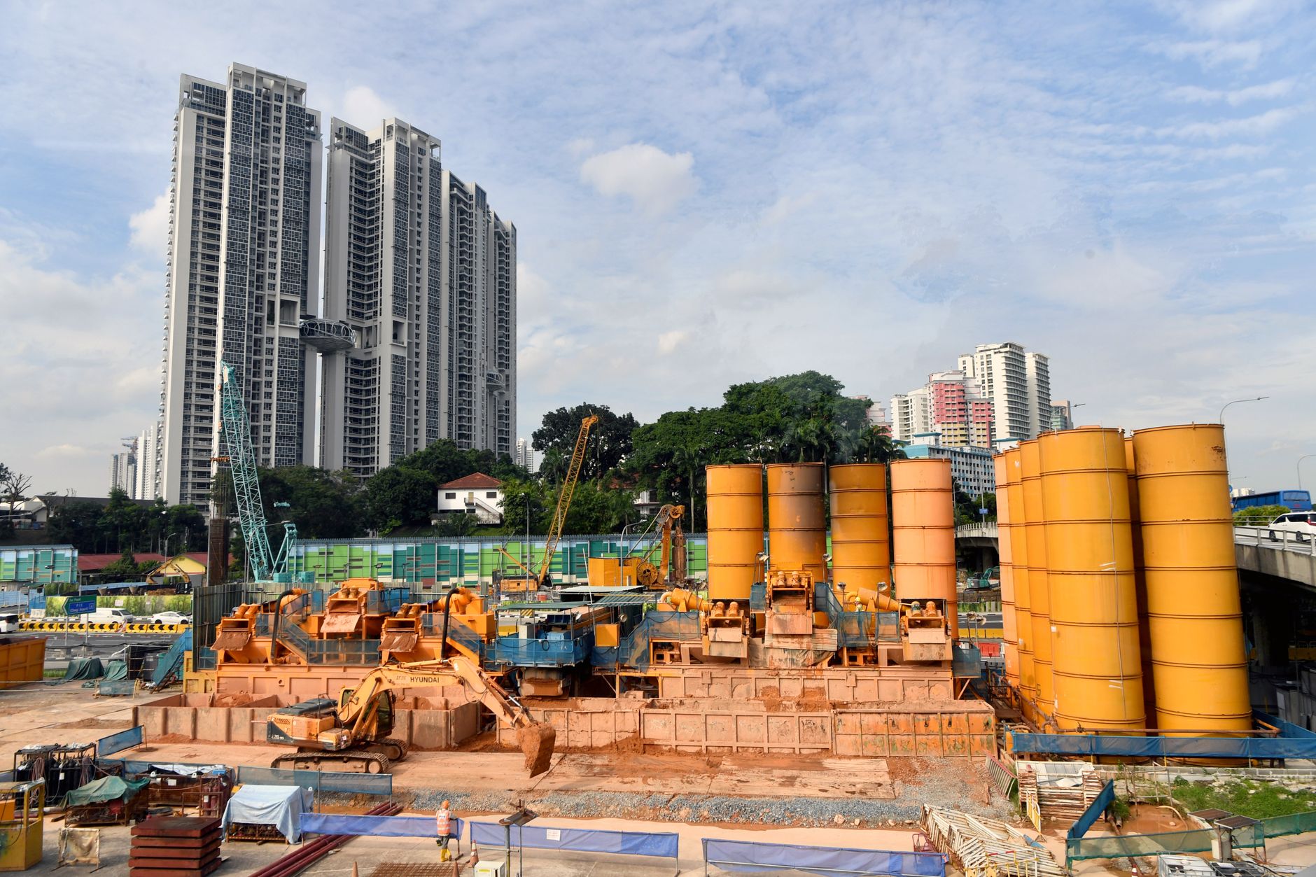 Cityscape featuring skyscrapers and an active construction site with yellow machinery.
