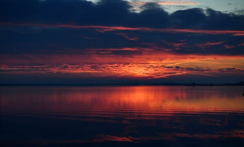 Sunset Over the Sea Covered with Clouds