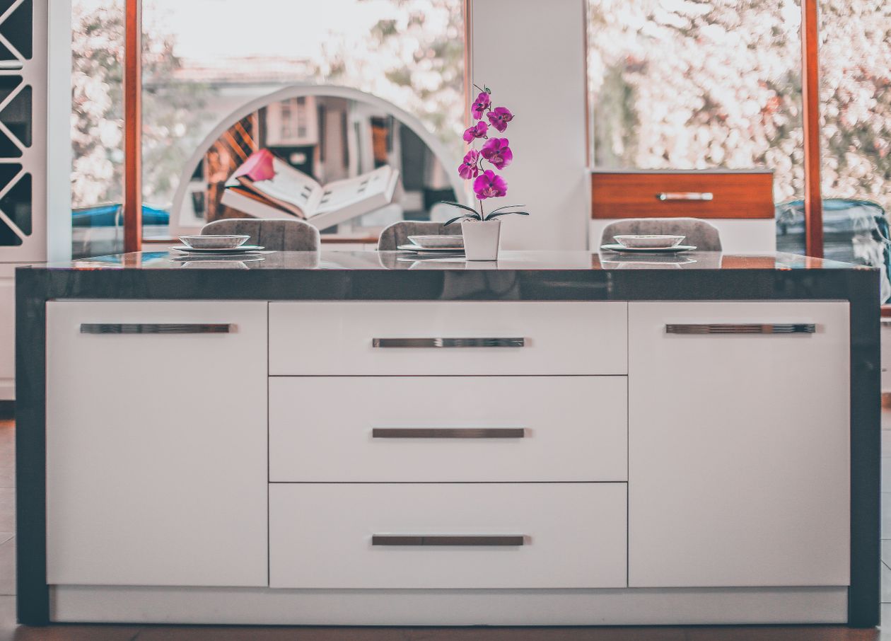 how to style a kitchen island: a kitchen island with an orchid decoration