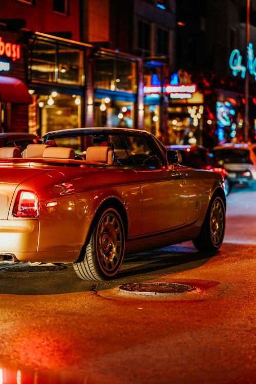 Free A luxurious convertible cruising through vibrant Ankara streets at night, capturing urban elegance. Stock Photo