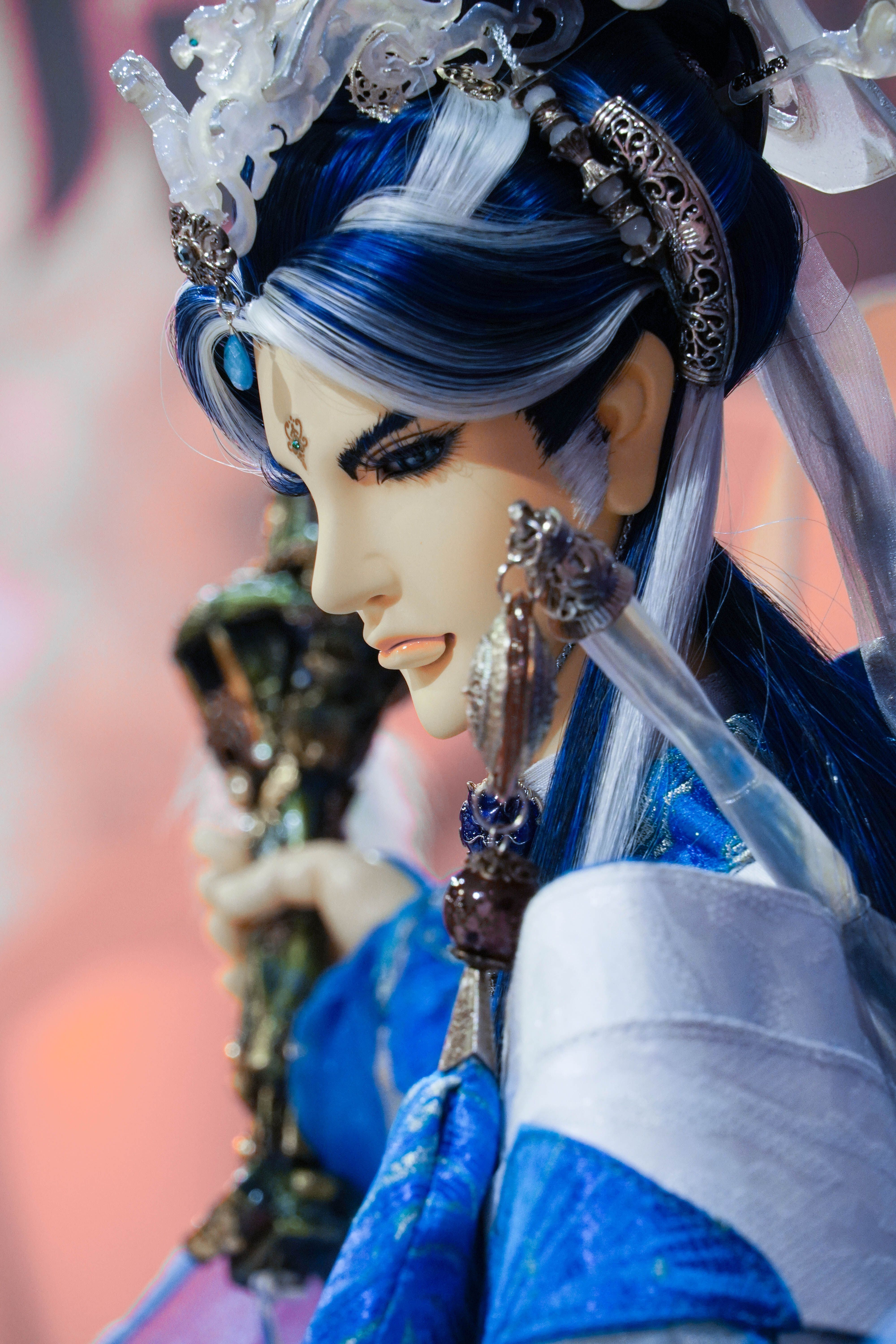 Close-up of an intricately decorated mannequin with blue accents and jewelry details.