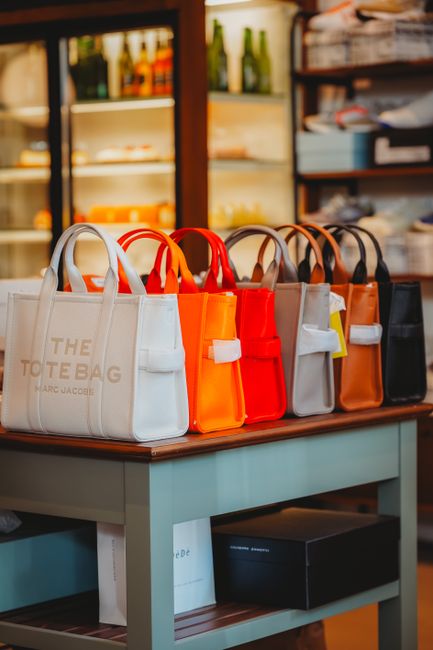 Vibrant handbags on display in a chic Ankara retail store. Perfect for fashion enthusiasts. - choose the right handbag for your budget