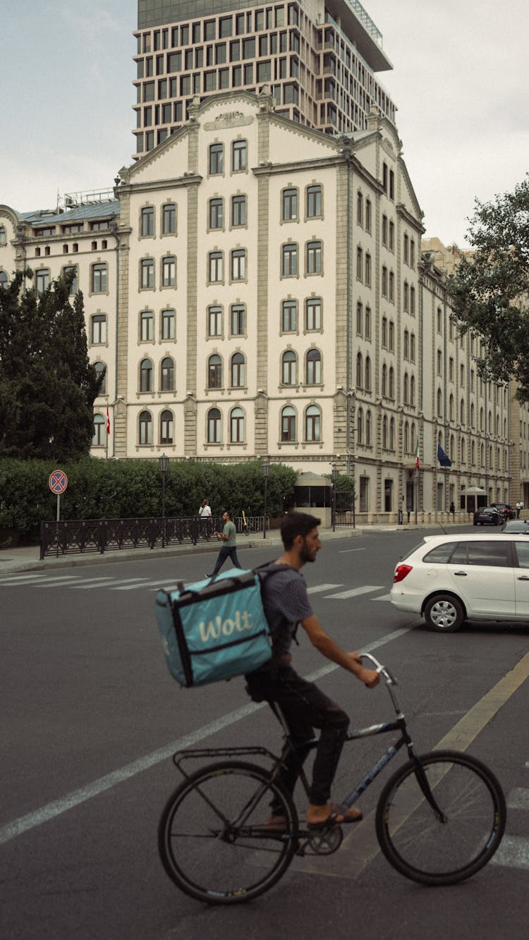 Man Delivering Food On Bike Against Skobelev Brothers Mill 