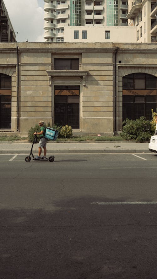 Man Delivering Food on Electric Scooter