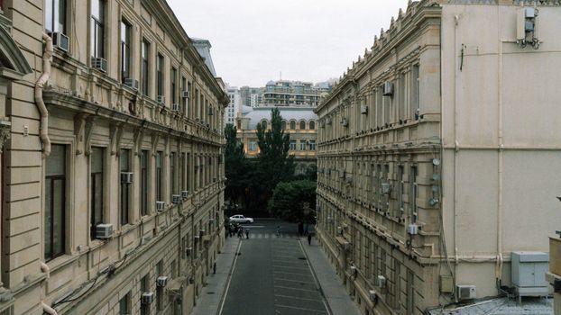 A scenic view of classic residential buildings lining a narrow street in Baku, Azerbaijan.