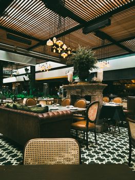 A luxurious indoor restaurant featuring classic decor with elegant wooden furniture and soft lighting.