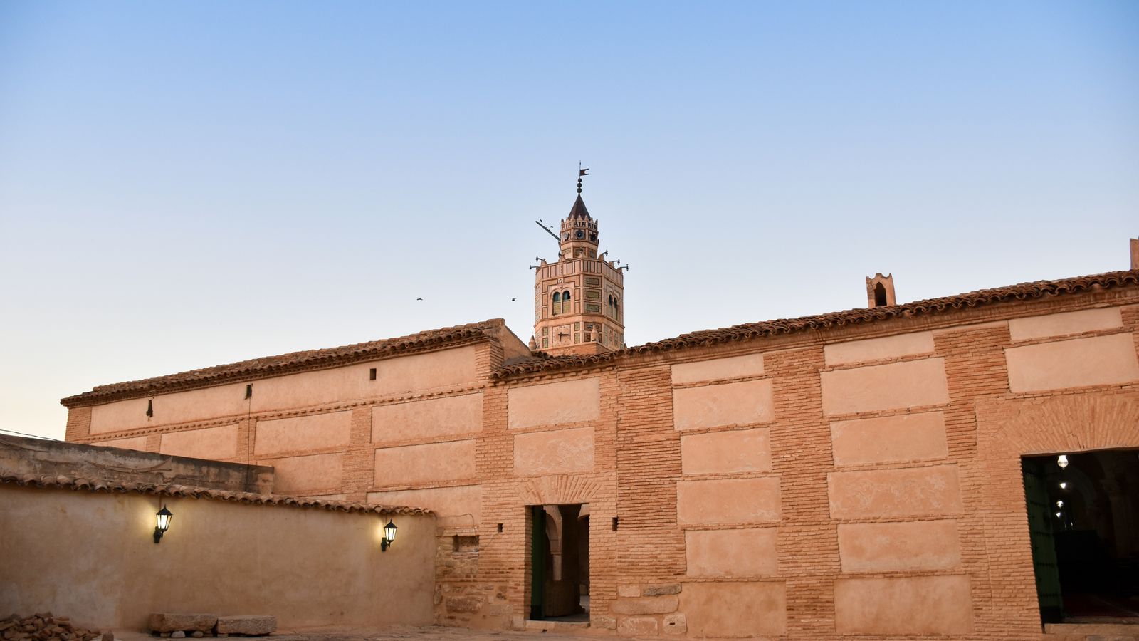 Minaret of great mosque of testour seen behind a building wall, Mali