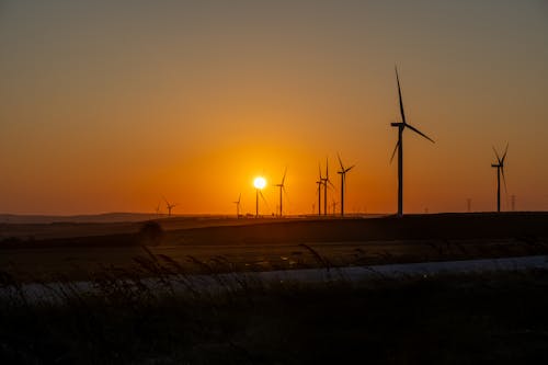 Silhouettes of Wind Farm Turbines at Sunset