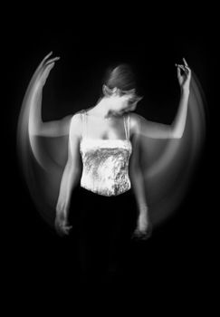 Black and white artistic portrait of a woman dancer with motion blur effects.