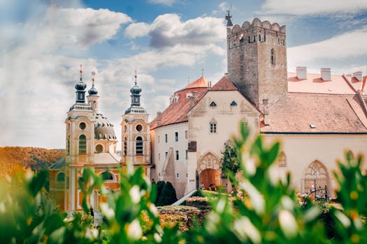 Beautiful view of a historic castle with towers and lush green foliage framing the scene.
