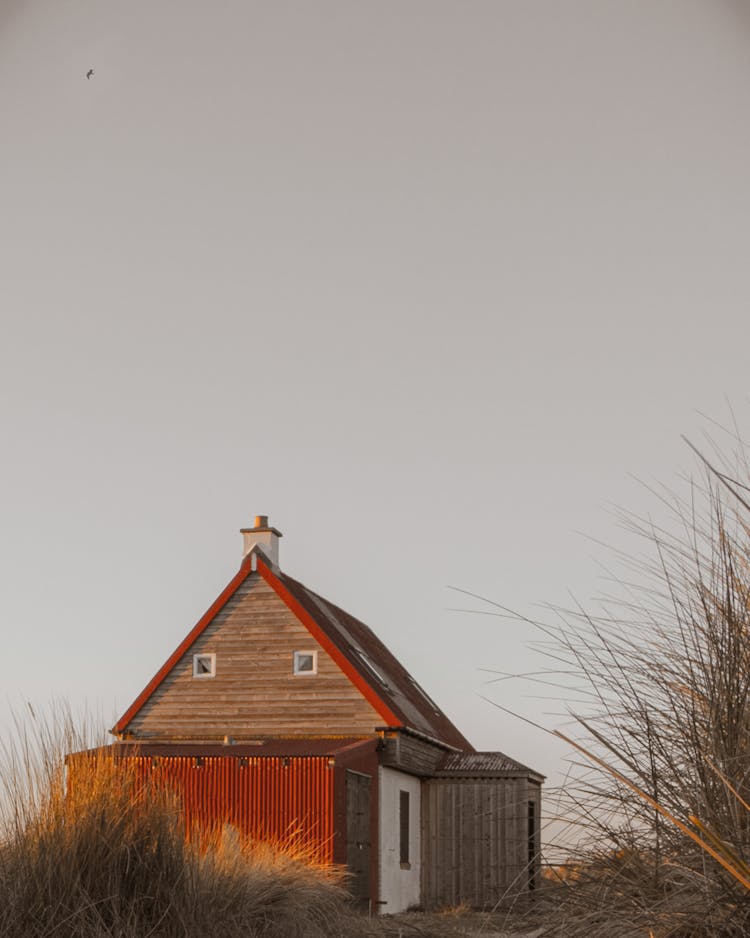 Wooden Small House With A Garage Built Of Corrugated Iron