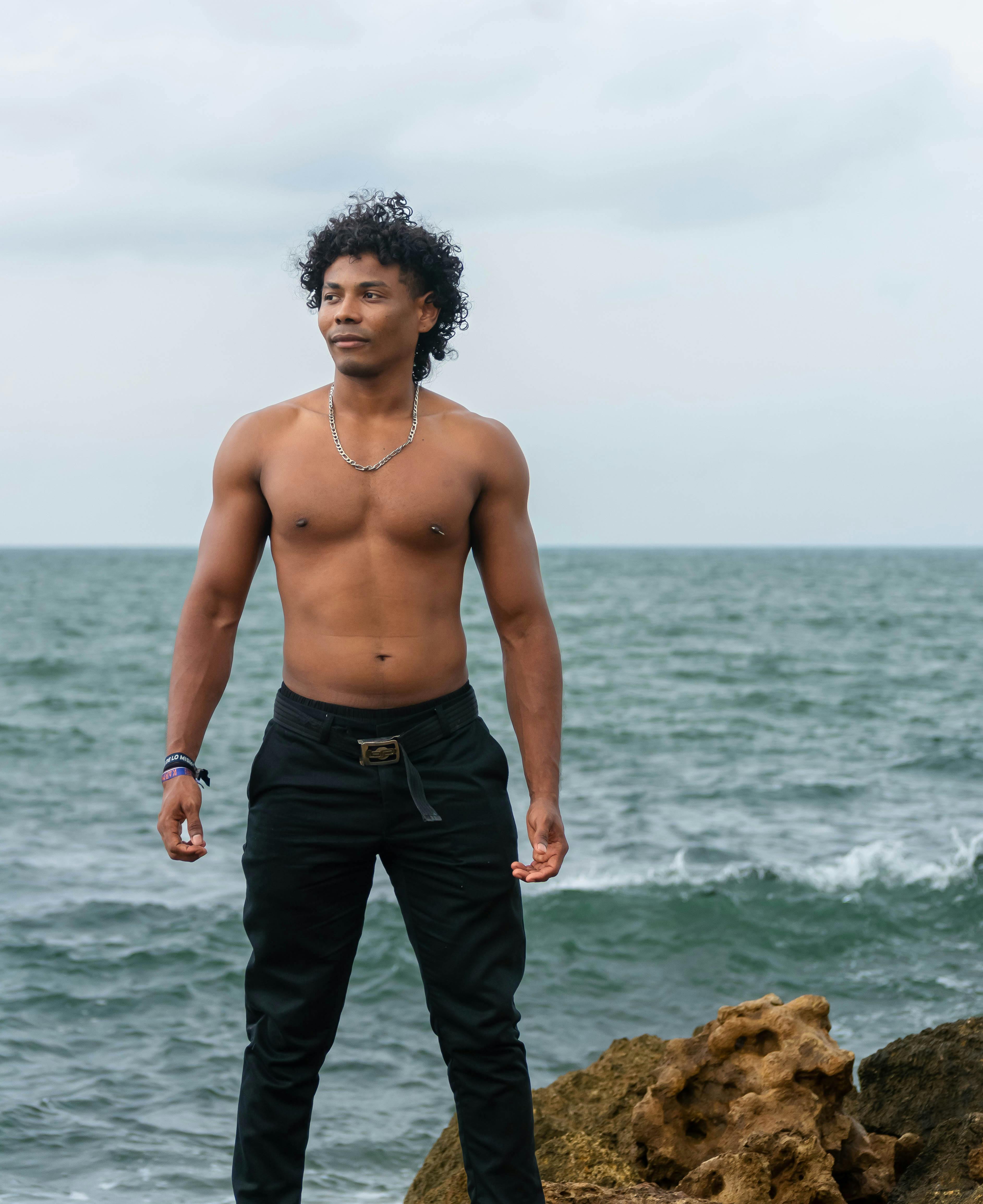 Handsome Shirtless Man Standing on Seashore · Free Stock Photo