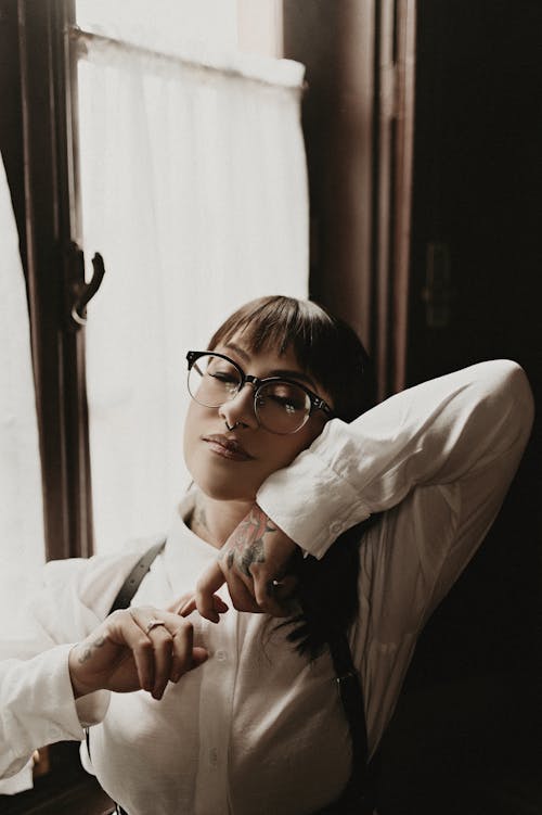 Young Woman Wearing Eyeglasses and a White Shirt