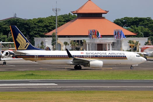 A Singapore Airlines Boeing 737-800 parked at a runway near an airport terminal.