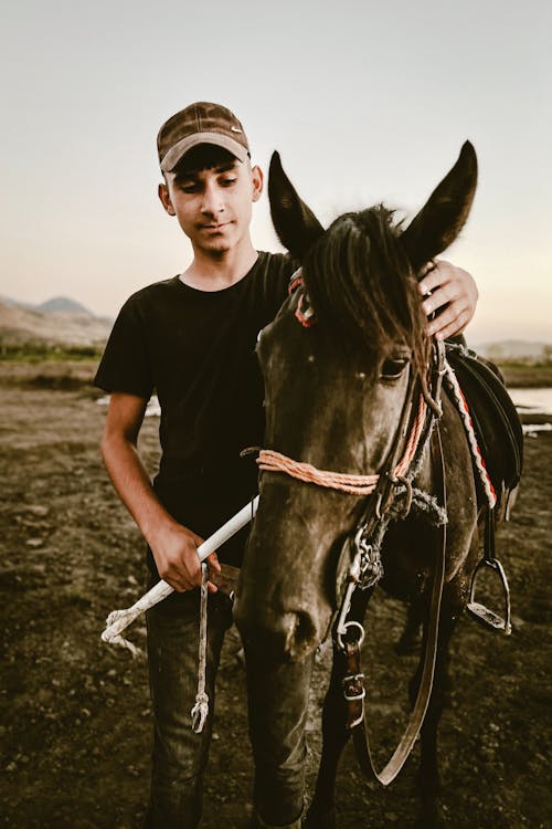 Young Man with Horse in Field
