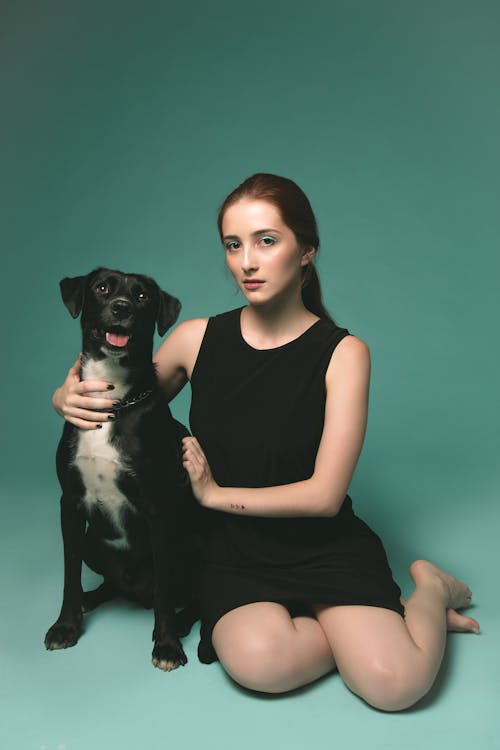 Photo of Woman Beside Dog