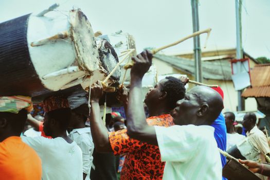 A lively festival scene in Cape Coast, Ghana, showcasing drummers celebrating with traditional music.