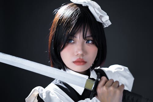 Young Woman in a Cosplay Holding a Sword