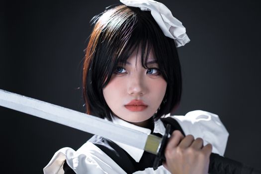 Dynamic portrait of a woman in cosplay holding a sword with intense focus.