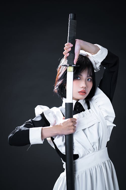 Young Woman in a Cosplay Holding a Sword