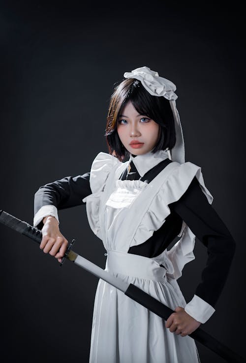 Free Young Woman in a Cosplay Holding a Sword Stock Photo