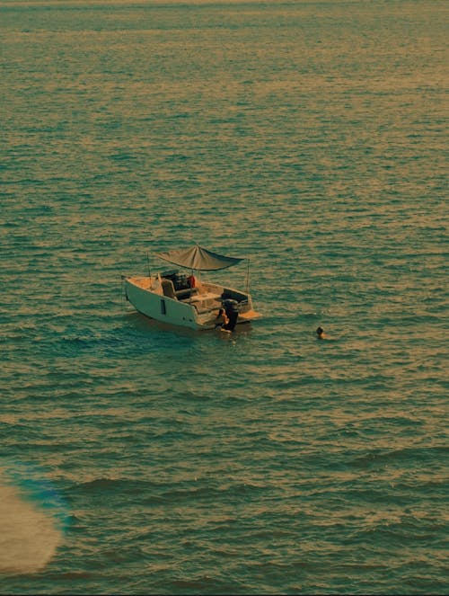 People Swimming around Motorbike