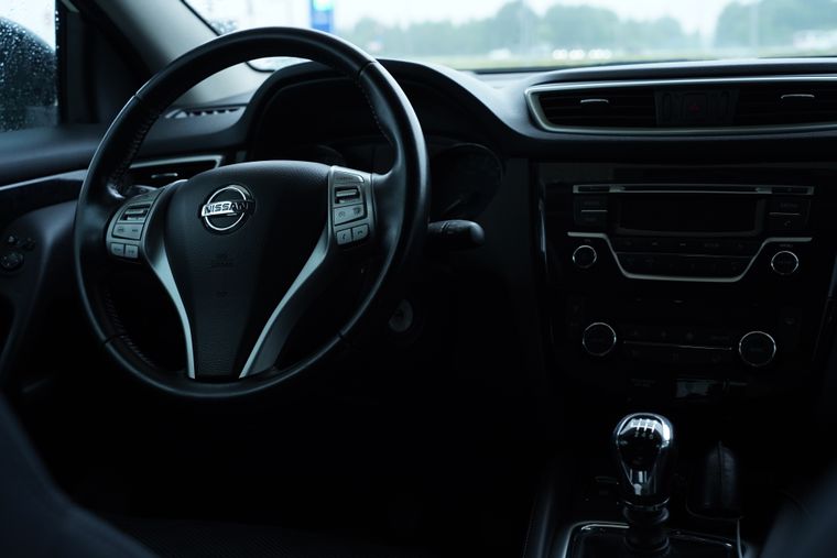 Dark car interior showing steering wheel and centre console, photo by Anastasiya Badun on Pexels