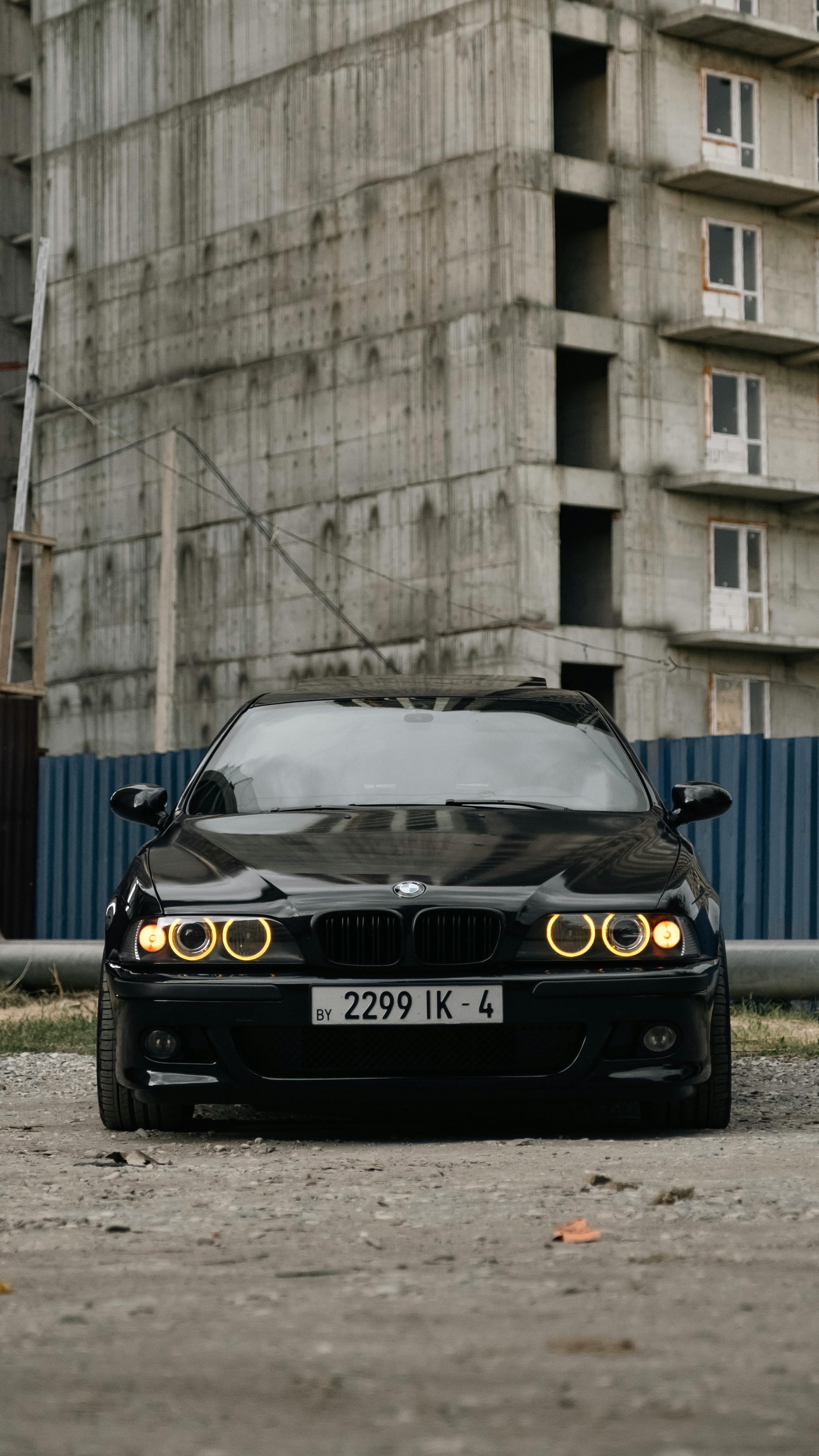 BMW E39 Parked Next to the Construction Site of an Apartment Building