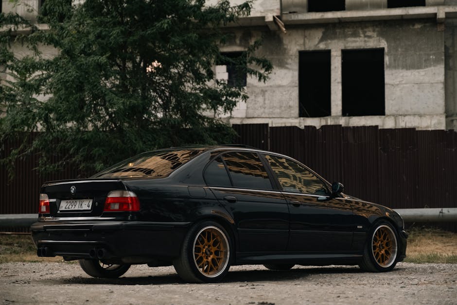 A sleek black car parked near a construction site in Grozny, Chechen Republic, Russia.