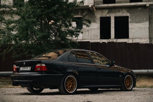 Free A sleek black car parked near a construction site in Grozny, Chechen Republic, Russia. Stock Photo