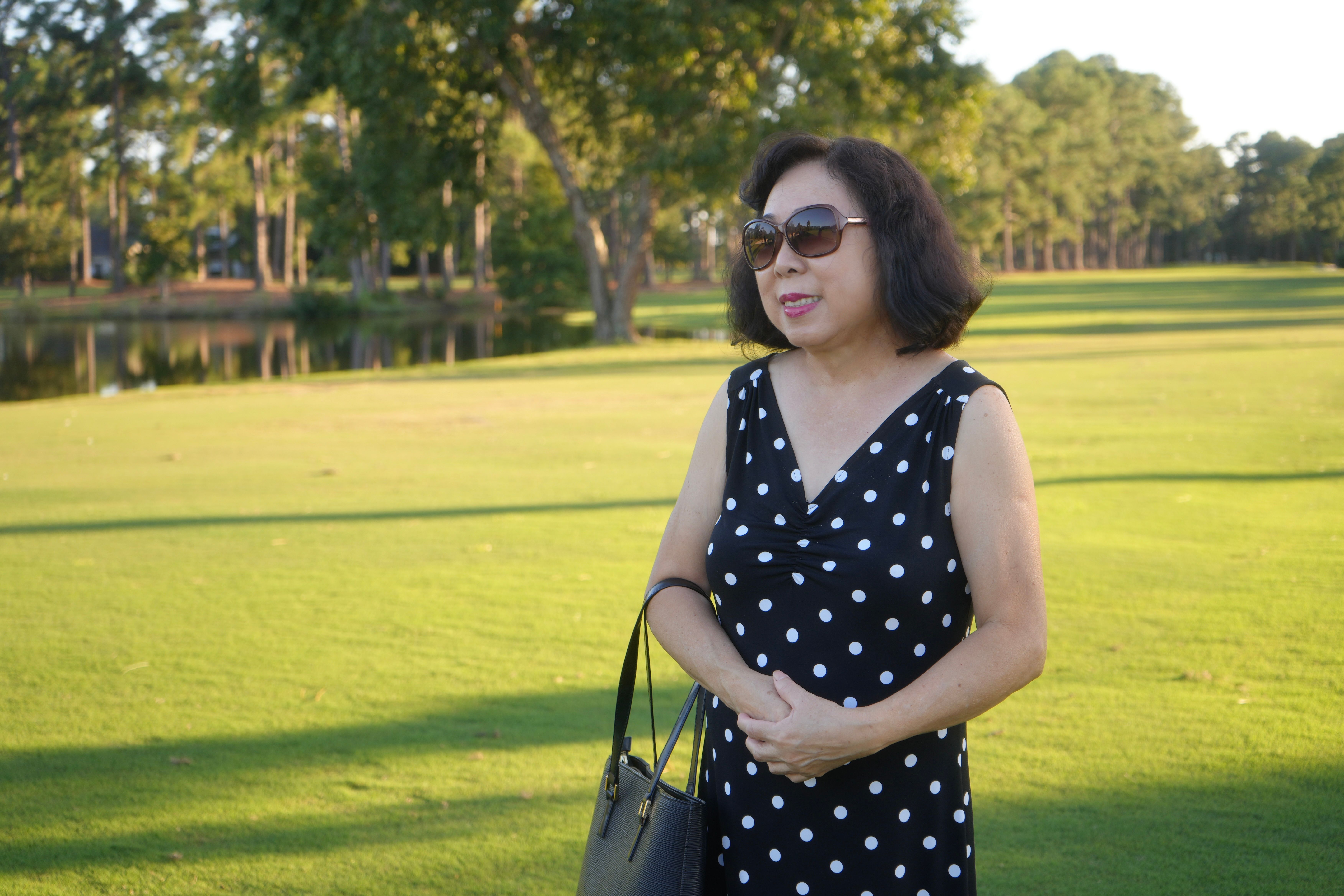 A woman in a bright polka dot outfit in an urban setting