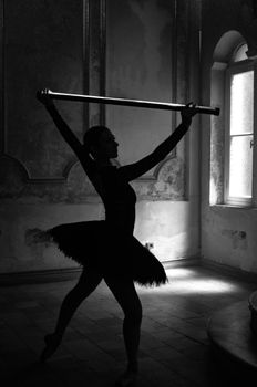 A dramatic silhouette of a ballerina dancing with a baton in a historic İStanbul setting.