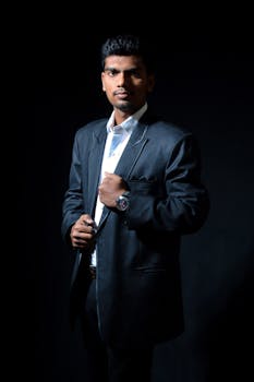 Elegant man in a suit posing confidently in a studio shoot, showcasing fashion and style.