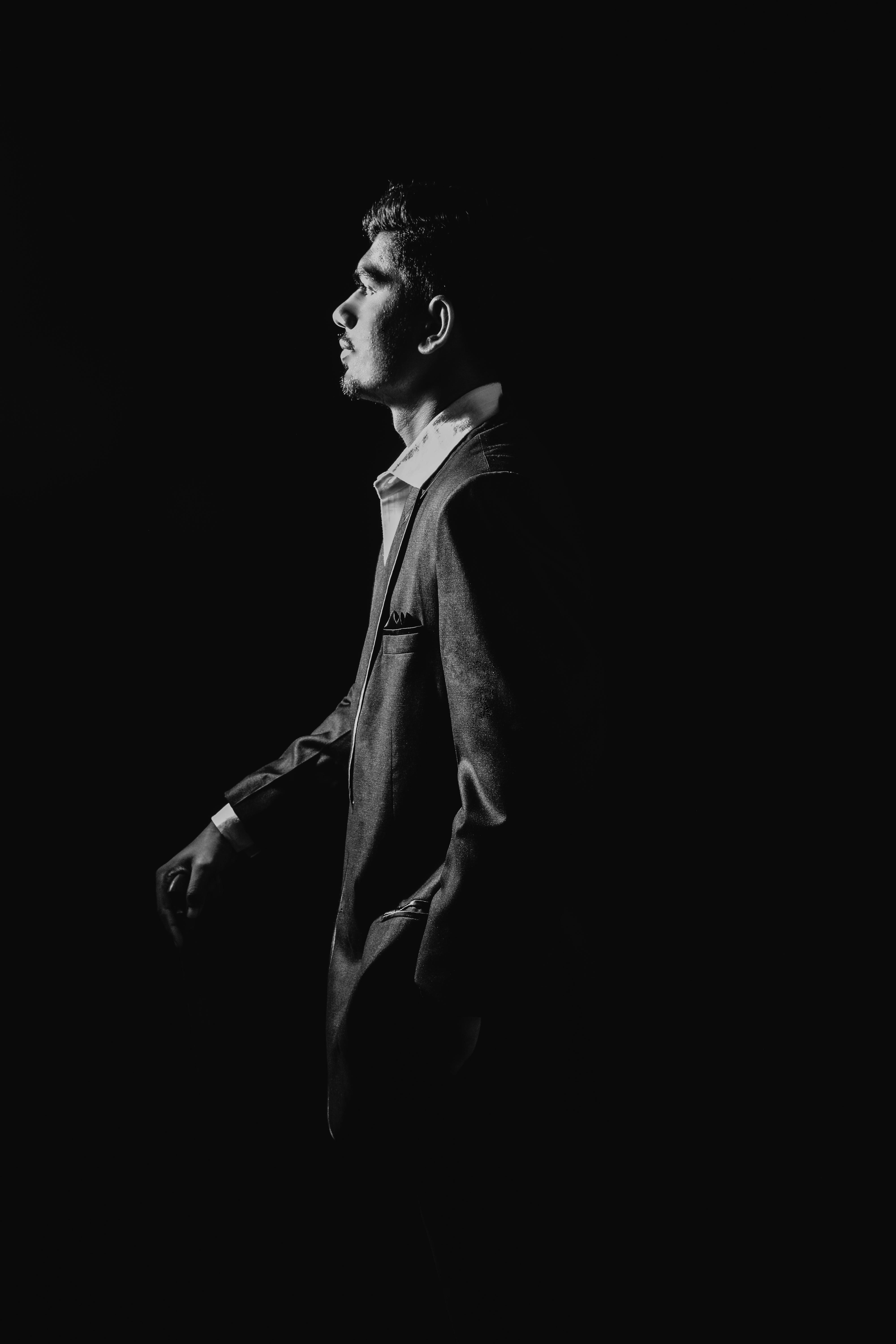 Elegant black and white portrait of a man in a suit, showcasing fashion and style.